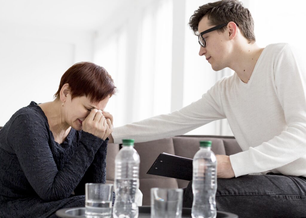 Person grieving the loss of a partner while coping with feelings of guilt and emotional distress after bereavement.