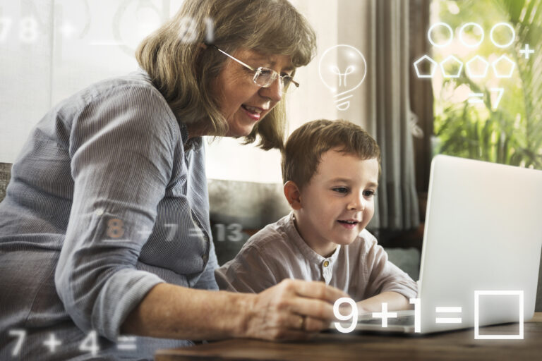 Children and senior citizens using digital devices together, highlighting the digital divide and the need for inclusive technology access.