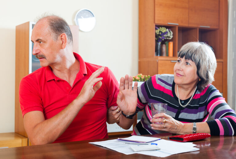Older adult showing stubborn or impulsive behavior while family members discuss age-related changes.