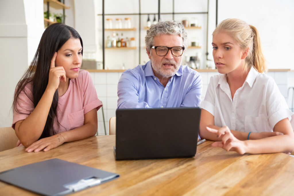 Older adult discussing important decisions with a family member and healthcare professional during a decision-making capacity assessment.