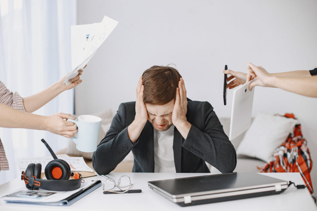 Person experiencing stress while working, showing the difference between everyday stress and burnout symptoms.