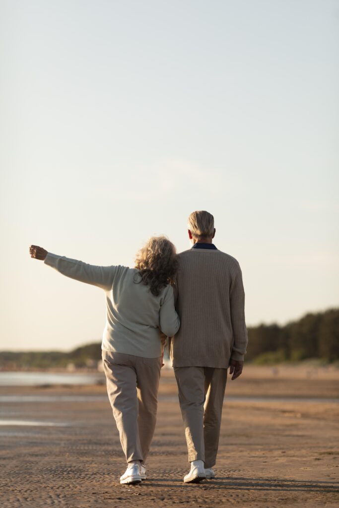 Older adult smiling confidently while embracing natural ageing with self-acceptance and a positive body image.