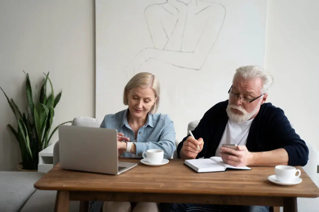 Older adult reviewing finances at home while feeling confident and emotionally secure