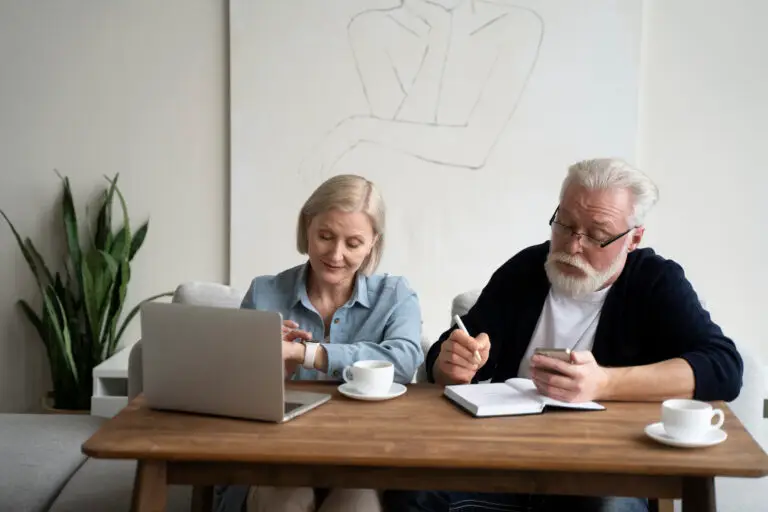 Older adult reviewing finances at home while feeling confident and emotionally secure