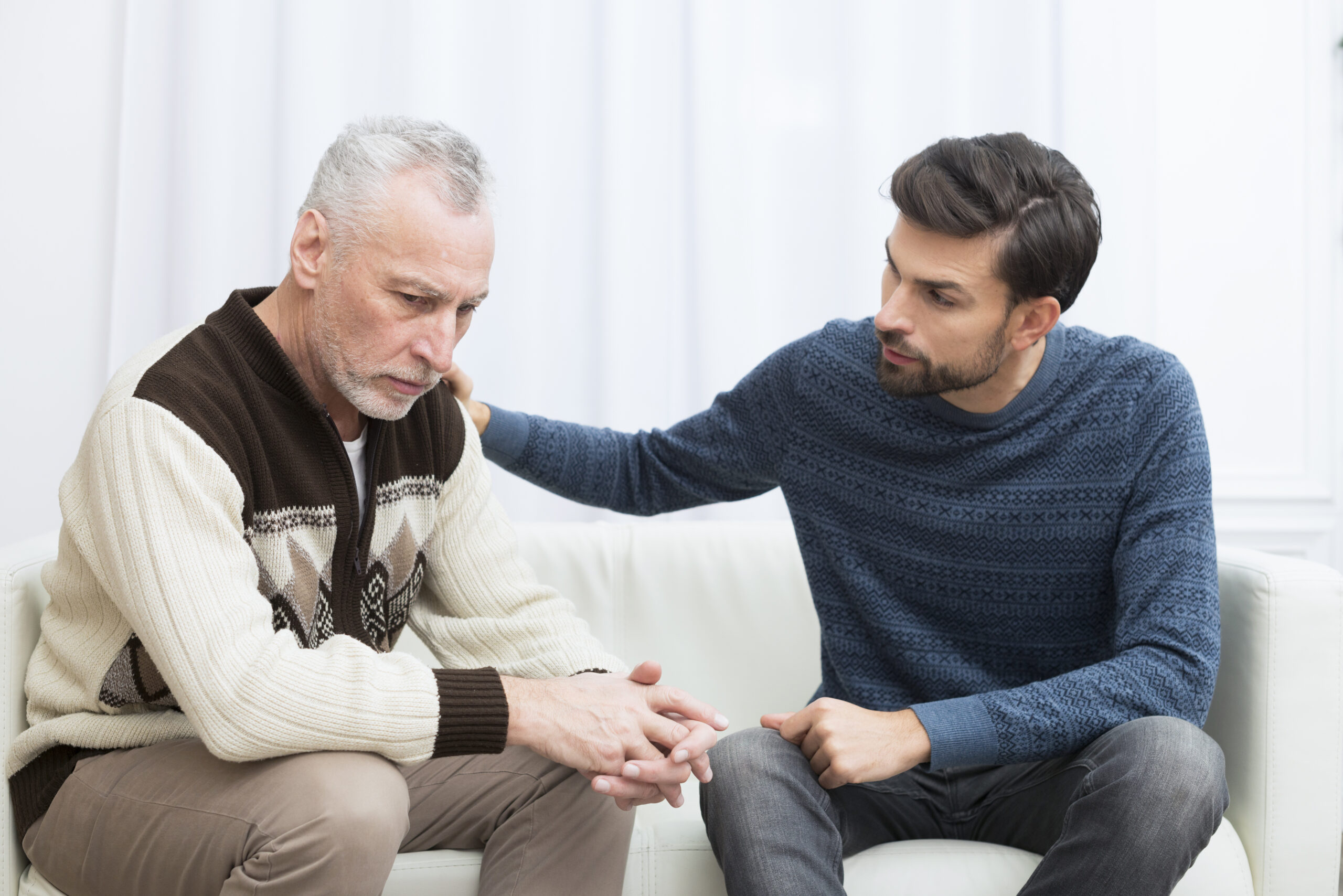 Adult son supporting his elderly parents at home while respecting her independence and dignity.